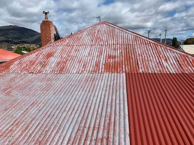 Corrugated iron — rust and patch repairs, out to charcoal before